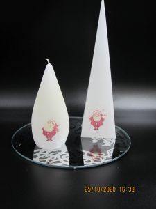 2 santa candles on a mirror plate
